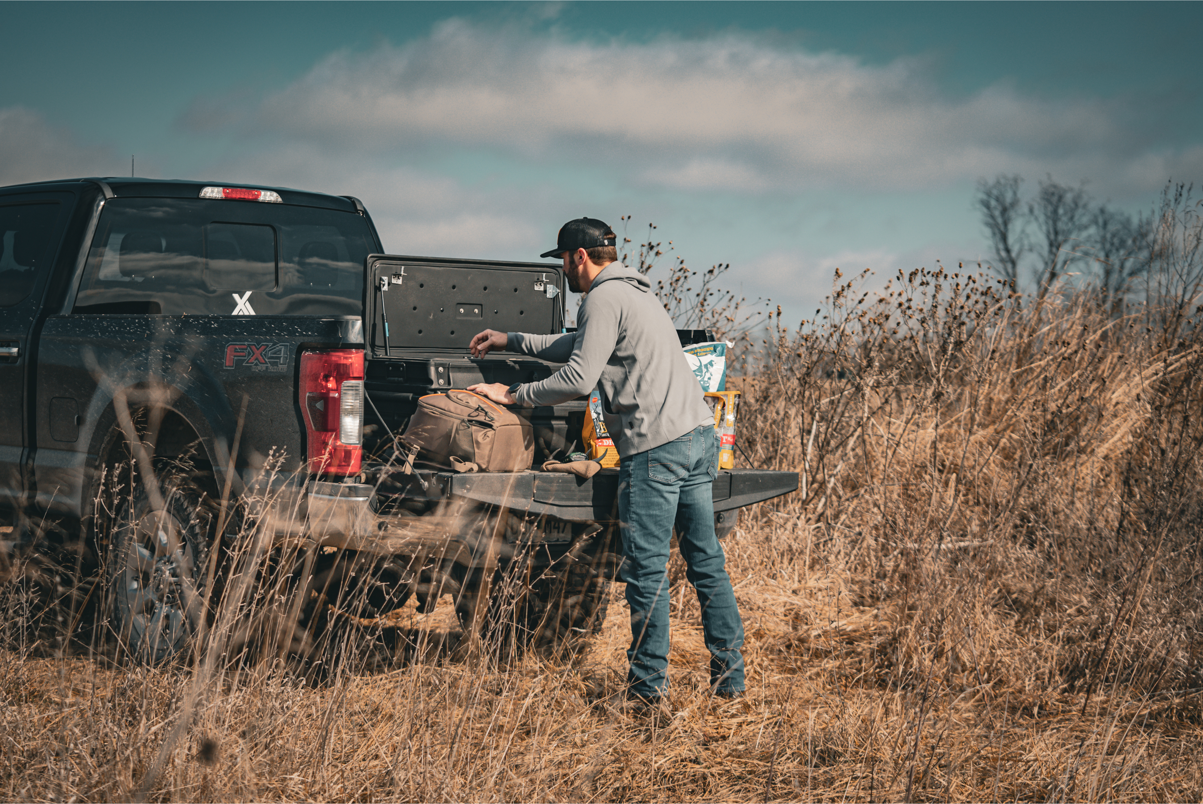 Image of a squad box being accessed at the tailgate of a truck.